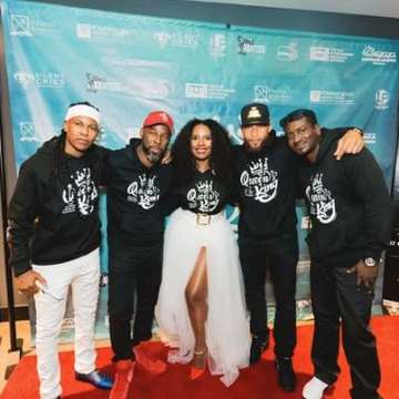 Cast and crew in Queen’s King hoodies on the red carpet