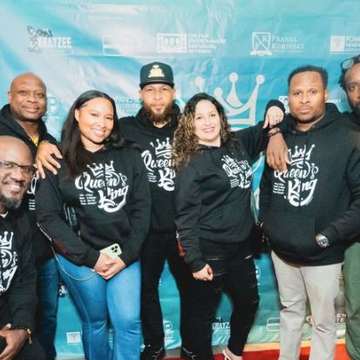 Community group in Queen’s King hoodies at the premiere