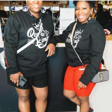 Two supporters in Queen’s King hoodies